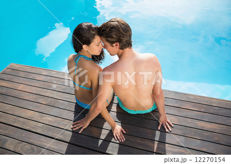 Romantic young couple by swimming pool 12270154