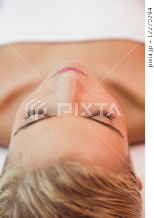 Beautiful woman lying on massage table at spa center 12270294