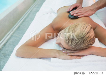 Woman receiving stone massage at health farm Woman receiving stone massage at health farm 12270384