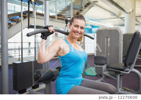 Fit brunette using weights machine for arms Fit brunette using weights machine for arms 12270600