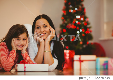 Festive mother and daughter smiling at camera 12270739