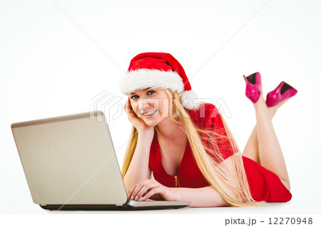 Festive blonde using a laptop Festive blonde using a laptop 12270948