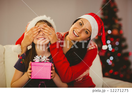 Mother surprising her daughter with christmas gift Mother surprising her daughter with christmas gift 12271275