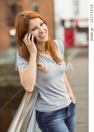 Smiling woman leaning on the bridge making a phone call Smiling woman leaning on the bridge making a phone call 12271419