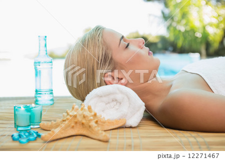 Beautiful woman lying on massage table at spa center Beautiful woman lying on massage table at spa center 12271467