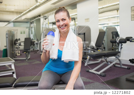 Fit brunette drinking from sports bottle 12271802