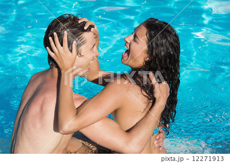 Couple playing in swimming pool Couple playing in swimming pool 12271913