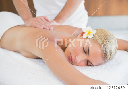 Woman receiving back massage at spa center Woman receiving back massage at spa center 12272089