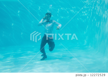 Young man swimming underwater Young man swimming underwater 12272529