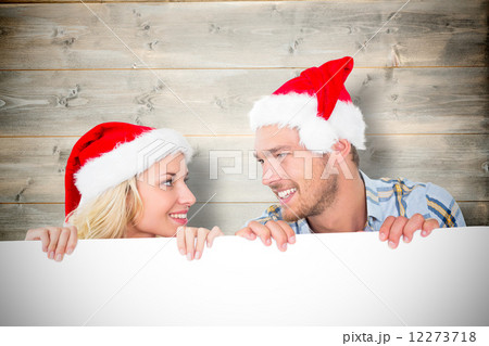 Composite image of young festive couple Composite image of young festive couple 12273718