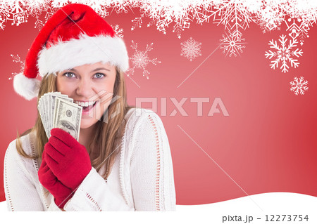 Composite image of festive blonde showing fan of dollars 12273754
