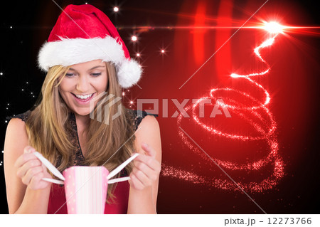 Composite image of festive blonde opening a gift bag Composite image of festive blonde opening a gift bag 12273766