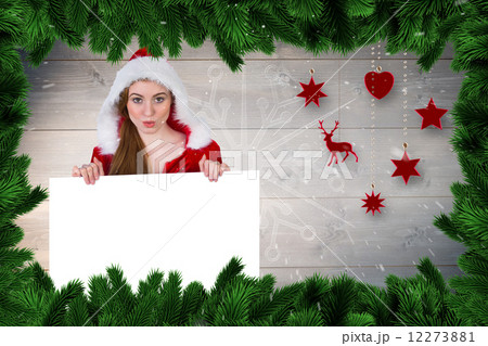 Composite image of pretty girl in santa costume showing card 12273881