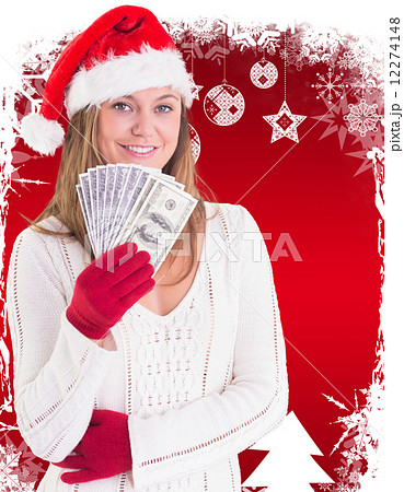 Composite image of festive blonde showing fan of dollars 12274148