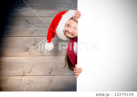 Composite image of festive little girl showing card Composite image of festive little girl showing card 12274150