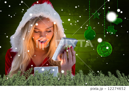 Composite image of sexy santa girl opening gift Composite image of sexy santa girl opening gift 12274652