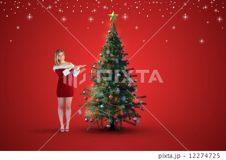 Composite image of pretty girl presenting in santa outfit Composite image of pretty girl presenting in santa outfit 12274725