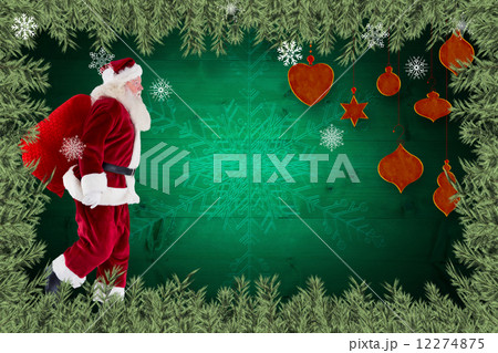 Composite image of santa claus carrying sack 12274875