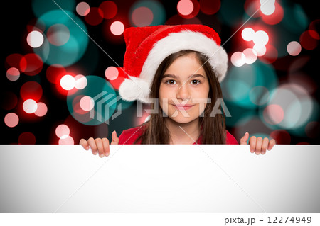 Composite image of festive little girl showing card Composite image of festive little girl showing card 12274949