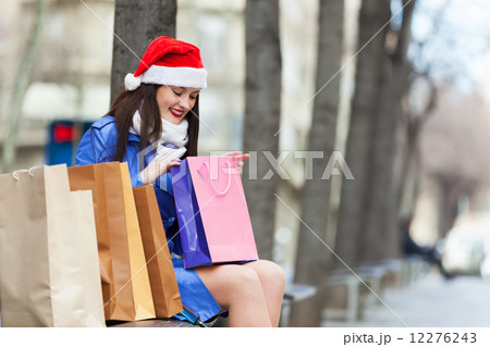 Woman with purchases at street Woman with purchases at street 12276243