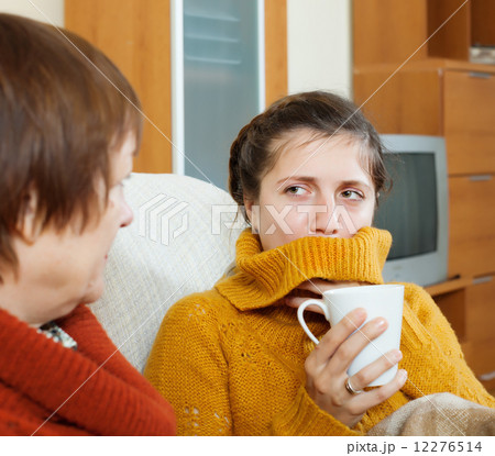 woman caring for her adult daughter has cold woman caring for her adult daughter has cold 12276514