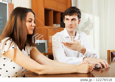 Serious couple talking in home 12276516