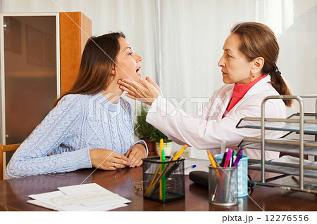 Doctor examining girl patient Doctor examining girl patient 12276556