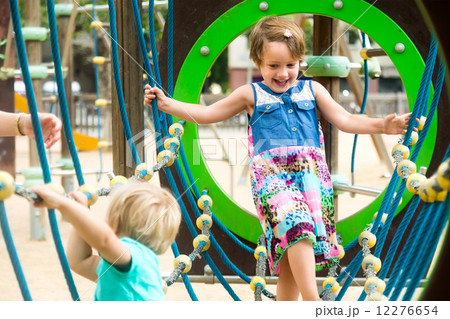 Little sisters at playground in park Little sisters at playground in park 12276654