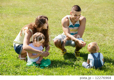 Family of four in sunny park Family of four in sunny park 12276968