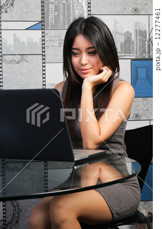 Pretty asian girl working on laptop 12277461