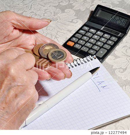 Hands of an old woman holding a coin Hands of an old woman holding a coin 12277494
