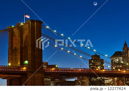 Close up of a pillar of the Brooklyn bridge with flag at night 12277624