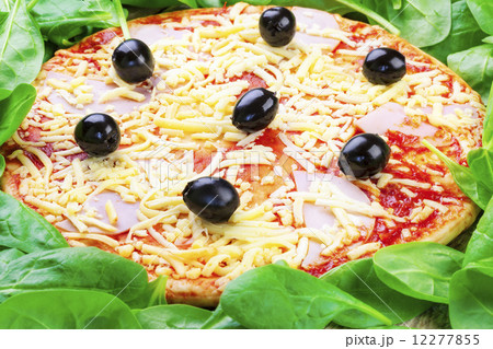 Delicious fresh pizza with green salad leaves around Delicious fresh pizza with green salad leaves around 12277855