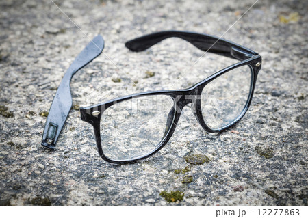 Broken black glasses fallen on tarmac Broken black glasses fallen on tarmac 12277863