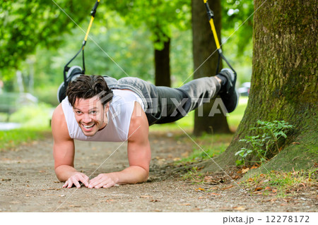 man doing suspension trainer sling sport 12278172