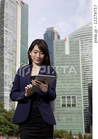 Businesswoman using tablet outdoors Businesswoman using tablet outdoors 12279757