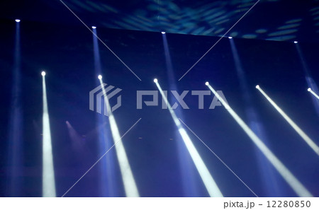 Multicolored light theatrical spotlights on a dark background 12280850