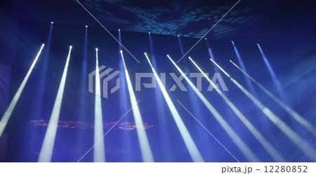 Multicolored light theatrical spotlights on a dark background 12280852