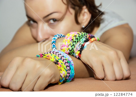 Young caucasian woman with colorful rubber bracelets on her hand Young caucasian woman with colorful rubber bracelets on her hand 12284774