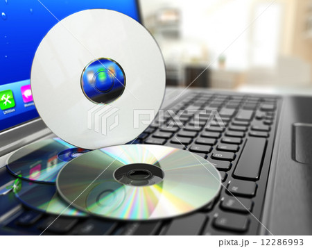 Software CD on laptop keyboard. Compact disks. 12286993