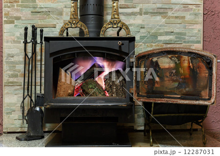 Old fireplace with a burning firewoods 12287031