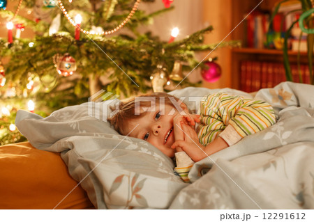 Little cute blond boy sleeping under Christmas tree Little cute blond boy sleeping under Christmas tree 12291612