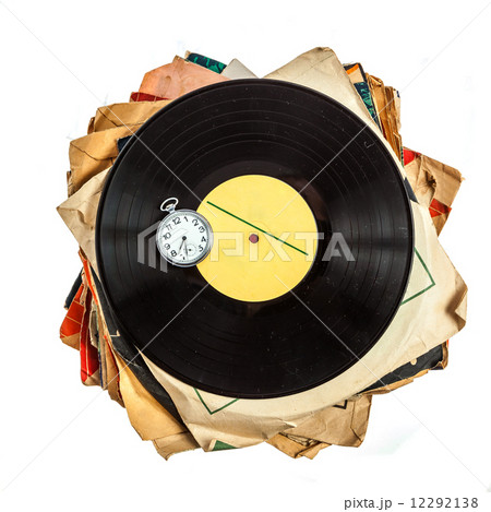 Stack of old scratched dusty vinyl records and pocket watch 12292138