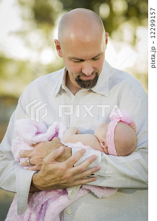 Young Handsome Father Holds His Newborn Baby Girl 12299157