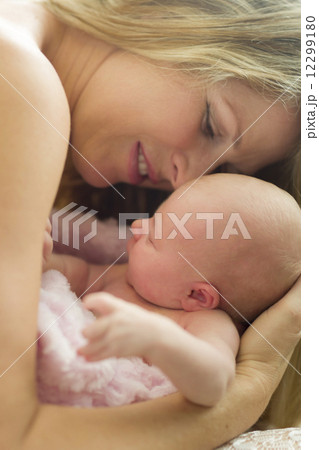 Young Beautiful Mother Holding Her Precious Newborn Baby Girl 12299180