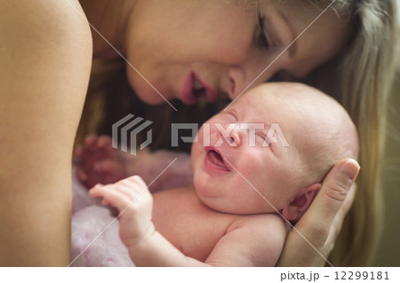 Young Beautiful Mother Holding Her Precious Newborn Baby Girl Young Beautiful Mother Holding Her Precious Newborn Baby Girl 12299181