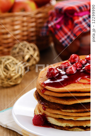 Delicious pancakes with raspberries on the kitchen table Delicious pancakes with raspberries on the kitchen table 12299990