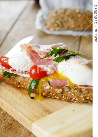 Bacon and poached eggs sandwich 12300931