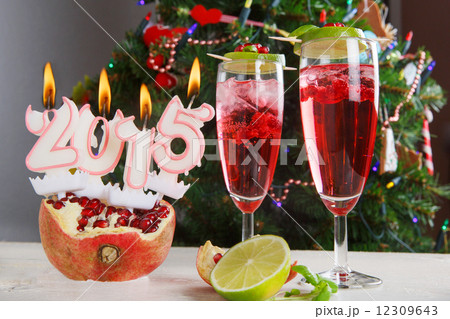 Two glasses with red champagne and candles 2015 Two glasses with red champagne and candles 2015 12309643