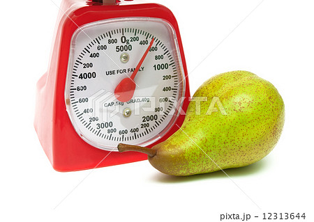 ripe pear and kitchen scales close up on a white background ripe pear and kitchen scales close up on a white background 12313644